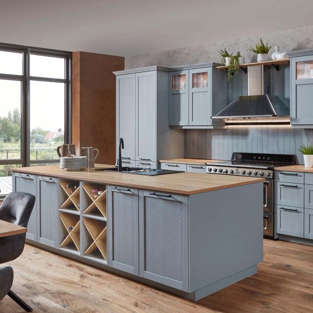 Nobilia Landhausküche in Blau mit Kücheninsel und Holzarbeitsplatte, integrierte Geräte und offene Weinregale, stilvolle Küche im klassischen Design